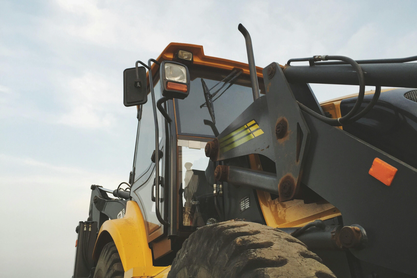A photograph of a semi truck hauling a large farm tractor.