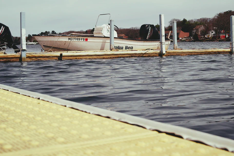 A photograph of a semi truck driving over a bridge.