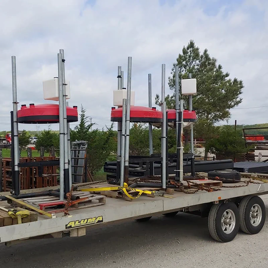 A photograph of a semi truck hauling livestock farm equipment.