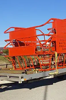 Photo of a semi truck hauling livestock equipment.